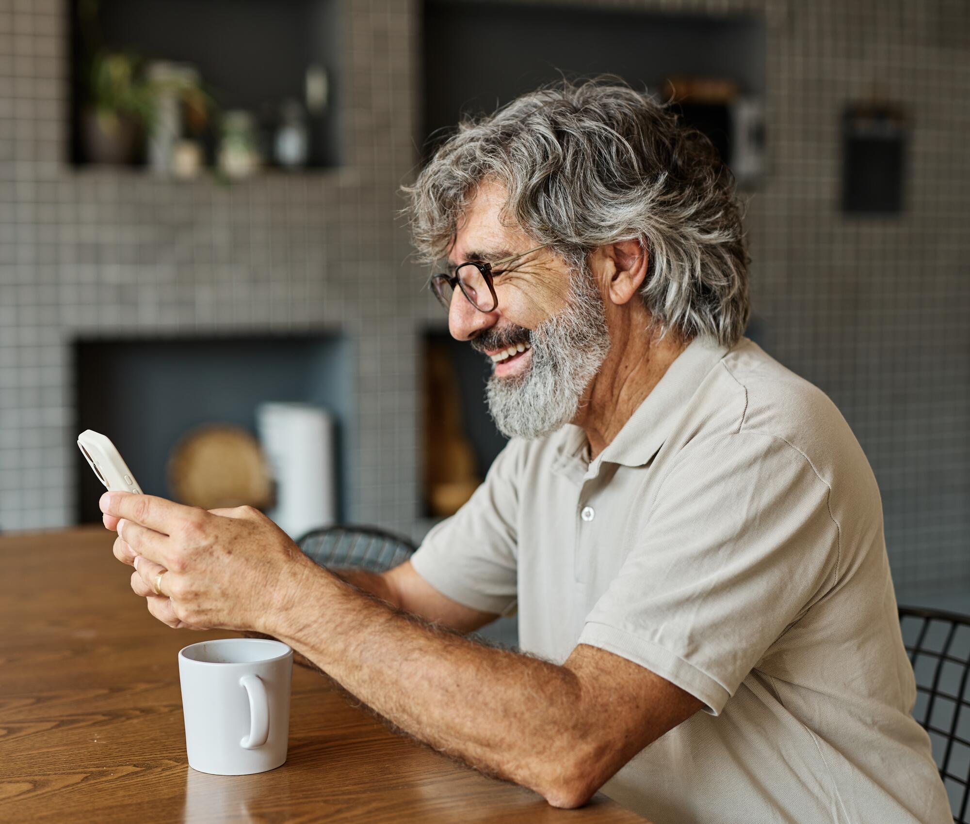 mature smiling man looking at his finances